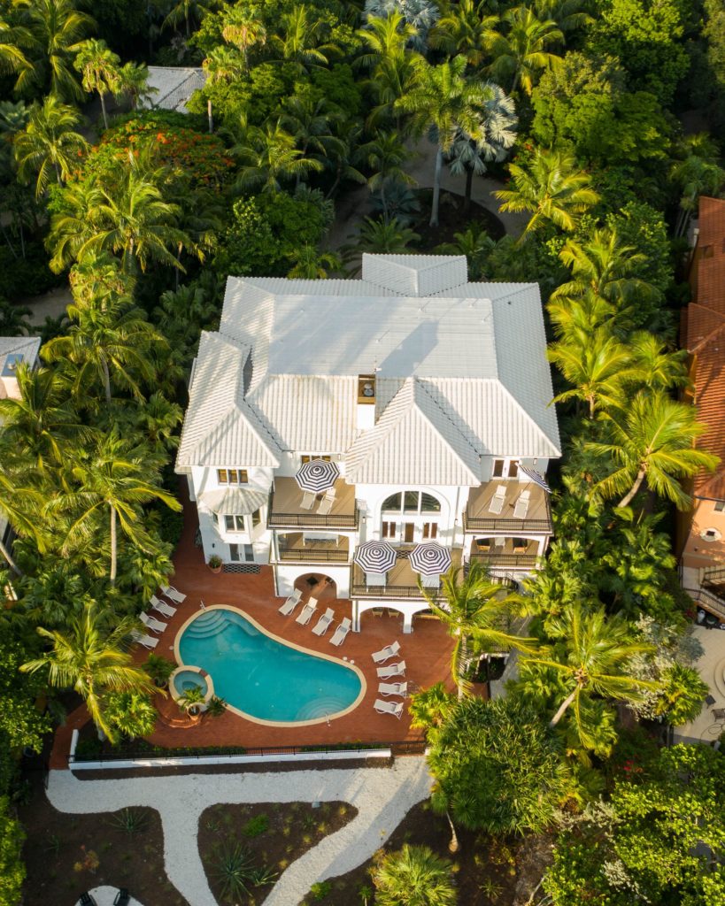 Bird's Eye View of Sea Palms Estate in Captiva Island, FL at dusk with pool, palm tree and chairs