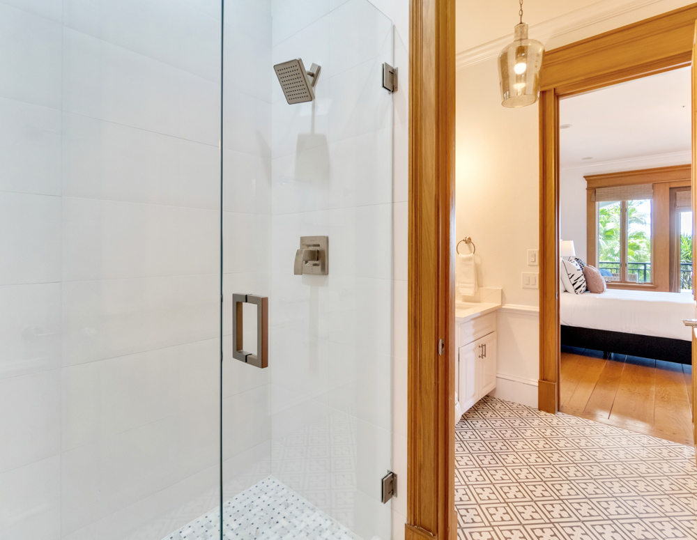 White standing shower in white bathroom adjacent to bedroom at the Sea Palms Estate in Captiva Island, FL